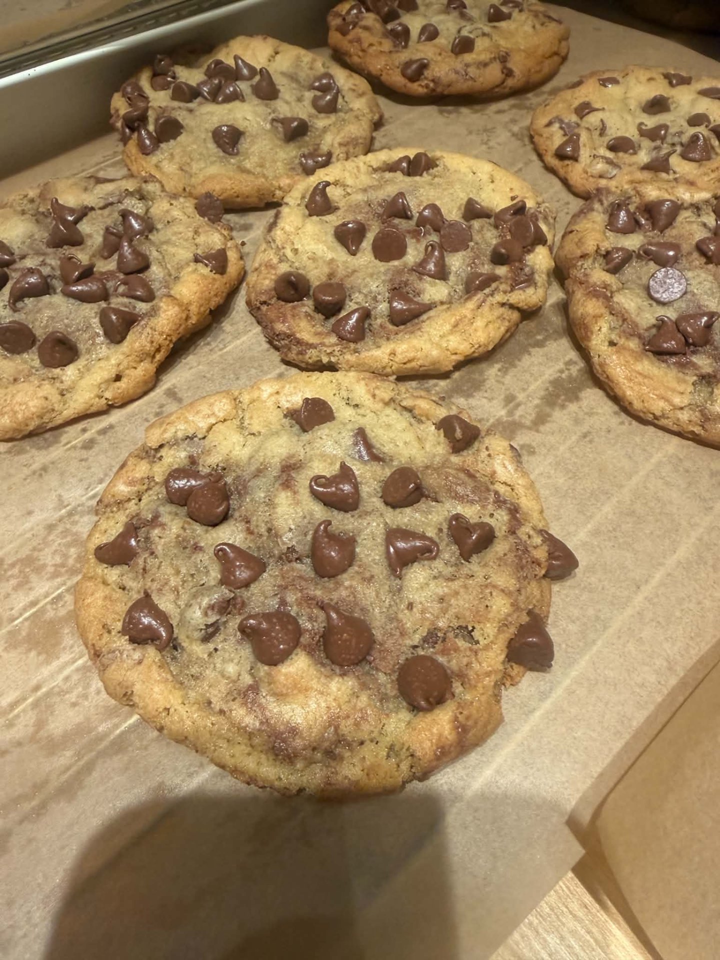 A fresh batch of homemade chocolate chip cookies on parchment paper
