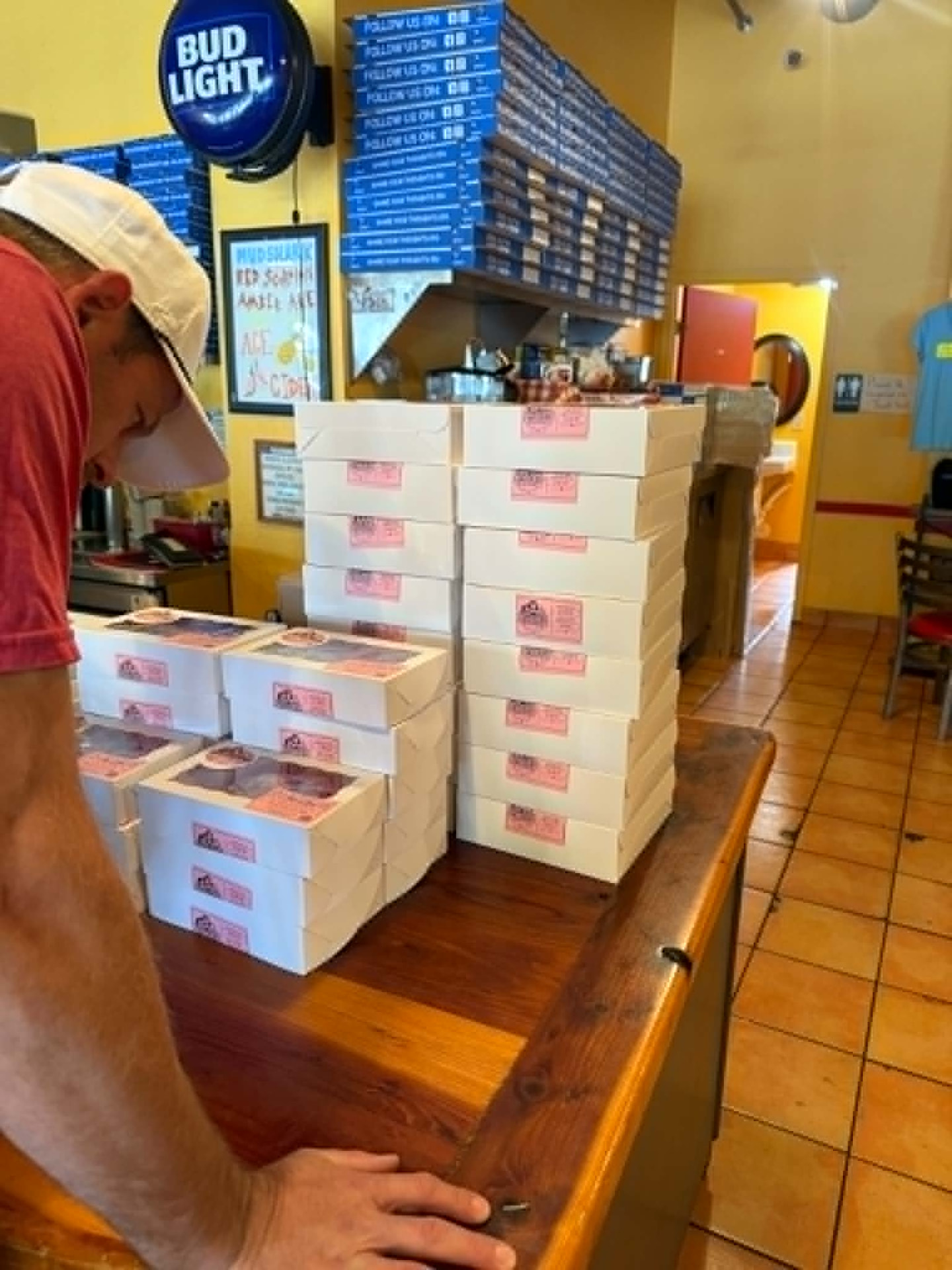 Stacks of Mommy & Me Goodies cookie boxes arranged on a counter